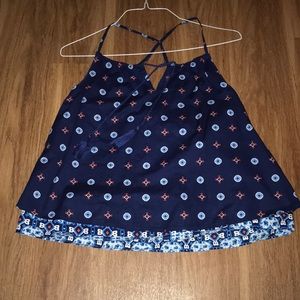 Blue crisscross tank with pattern all over.